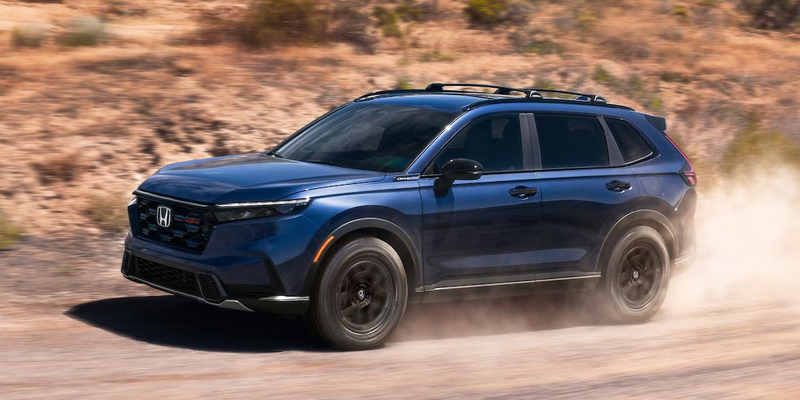 2026 Honda CR-V driving on dusty off-road trail in blue
